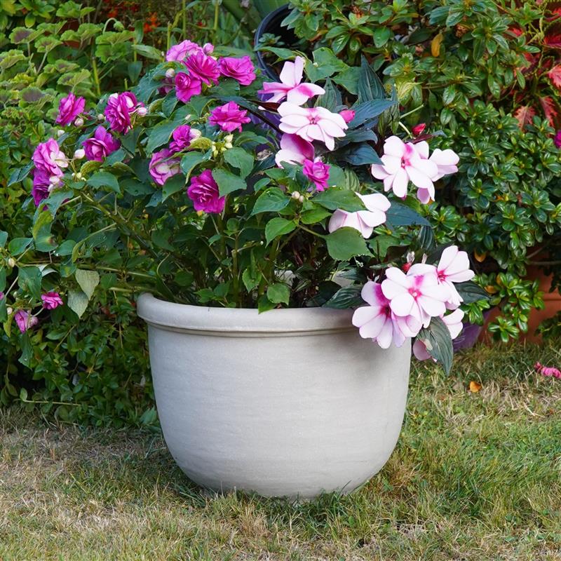 Crescent Garden Agave planter in color Parchment with flowers inside