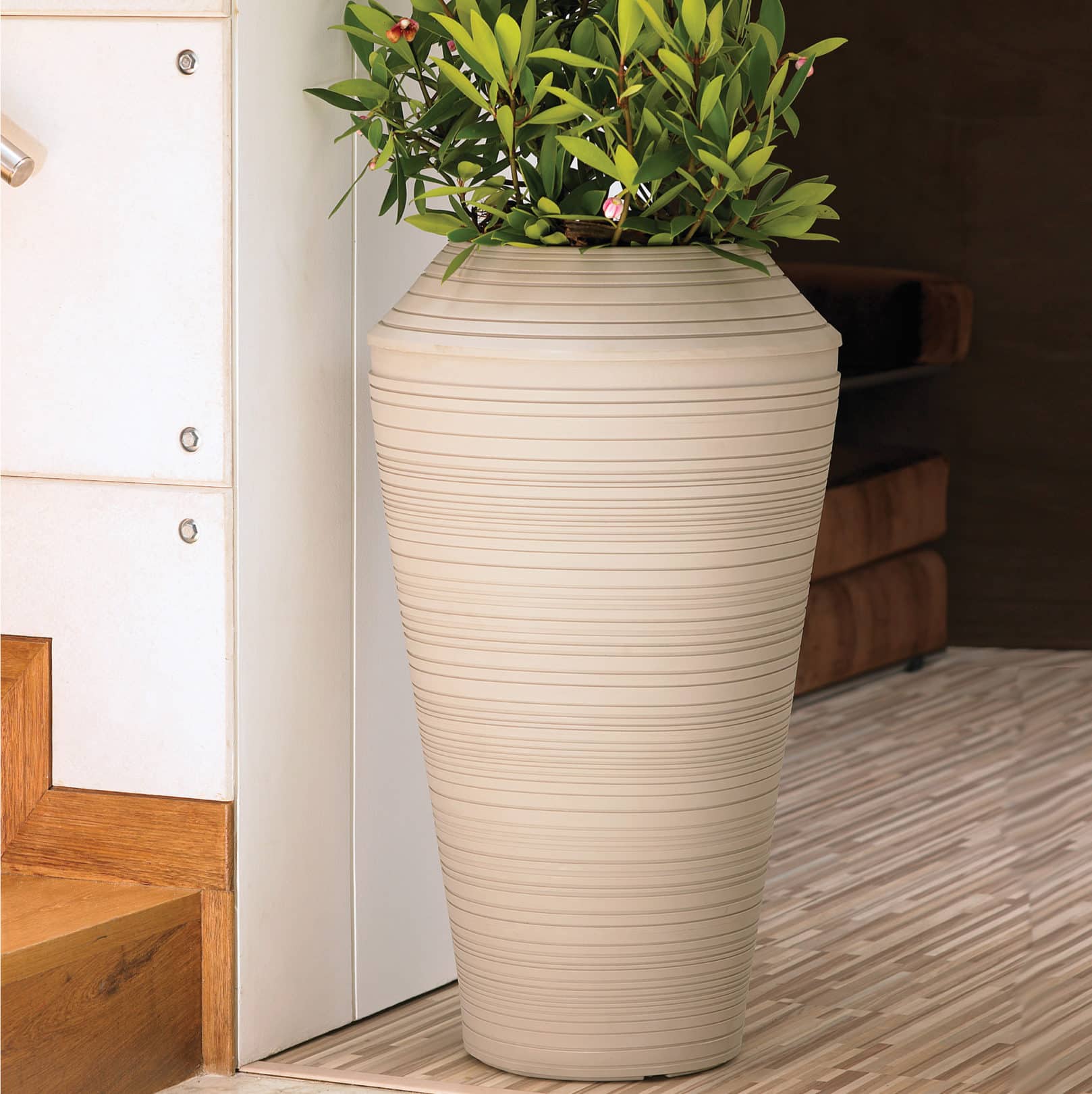Daniel Tall Planter in Weathered Stone by staircase