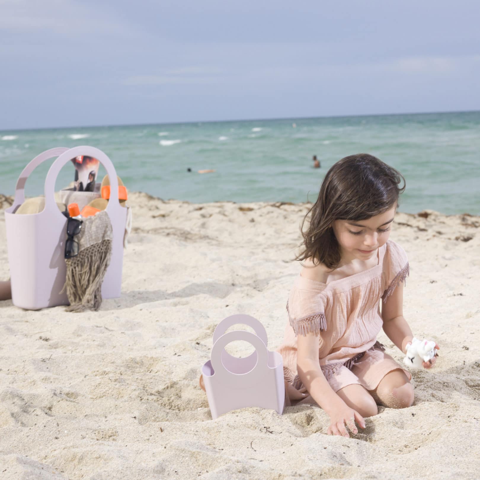 girl at beach with gabrielle bags