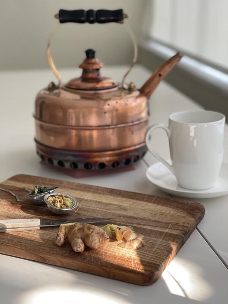 Brass tea pot and fresh herbs.